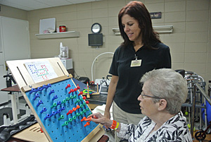 nurse and patient working on therapy board